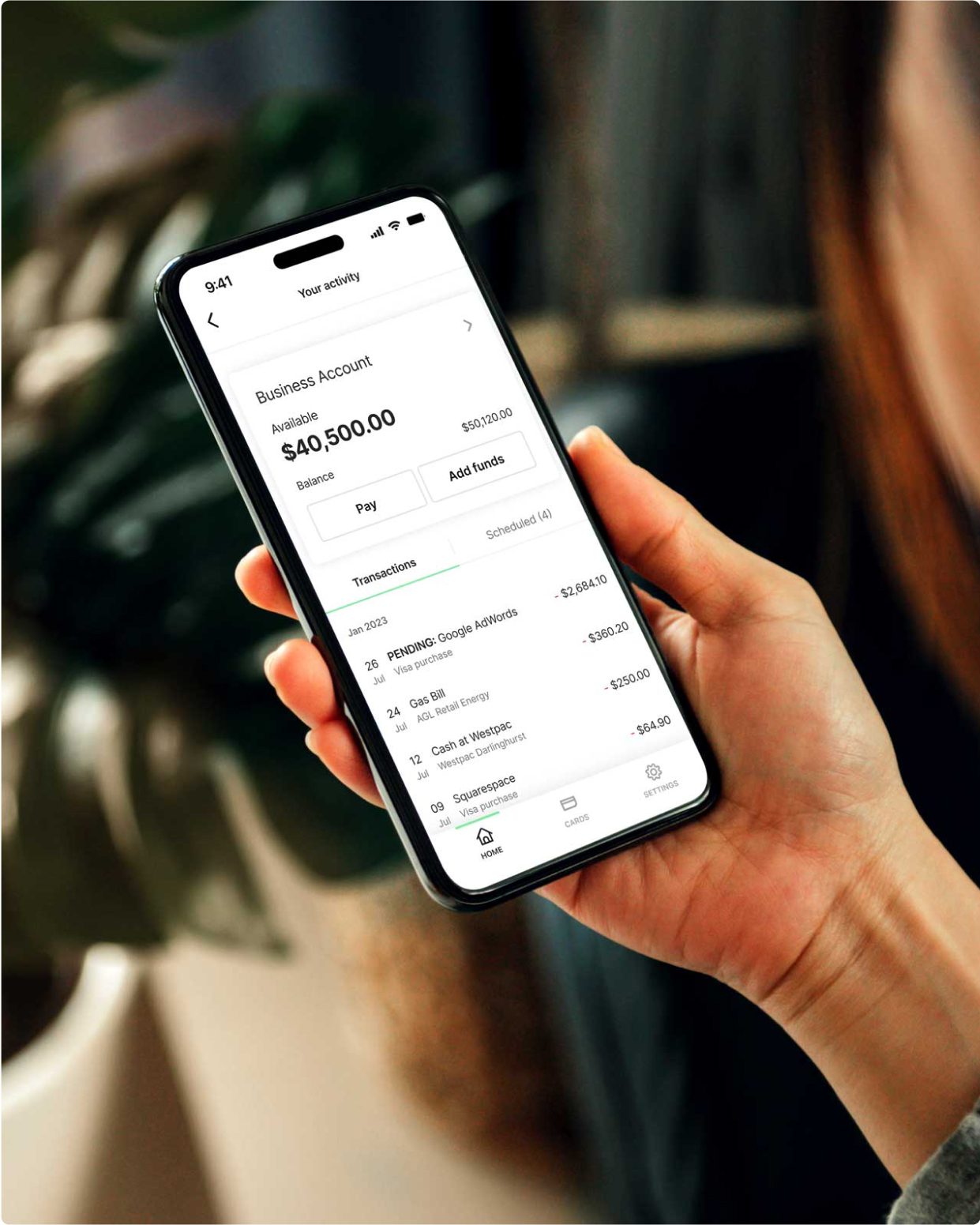 Mobile phone displaying a customer's available funds and transaction history for their Prospa Business Account