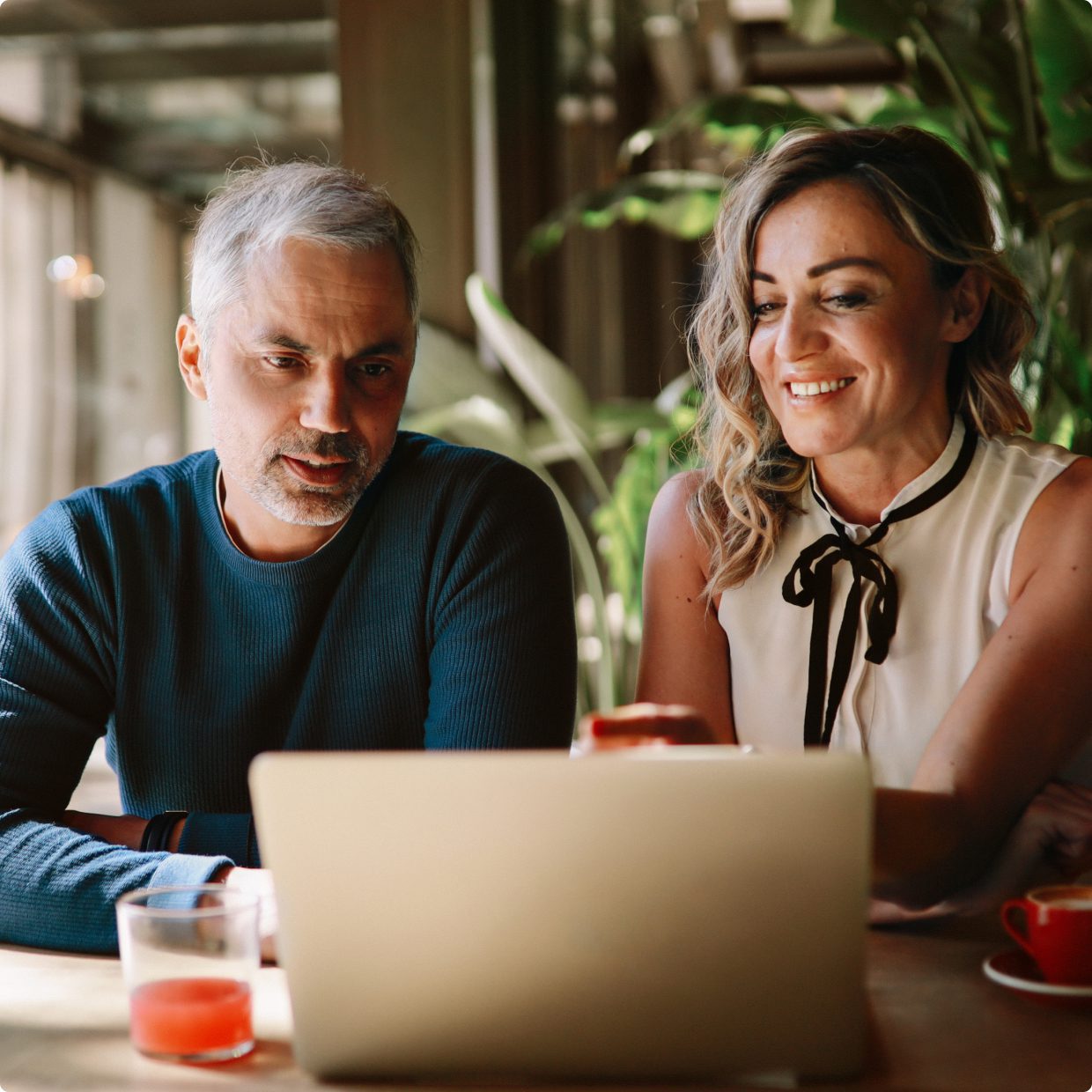 Man and woman working together on laptop