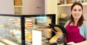 small business owner taking an order at a cake shop