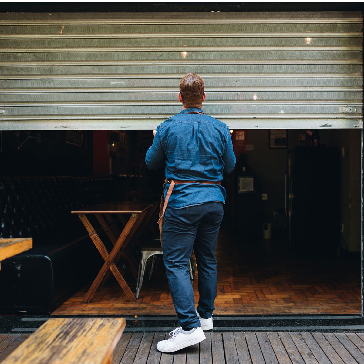 Business owner closing shutters