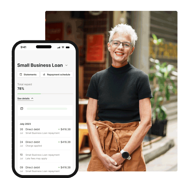 A person standing outdoors in casual workwear beside a smartphone screen displaying a small business loan dashboard with repayment progress and recent transactions.