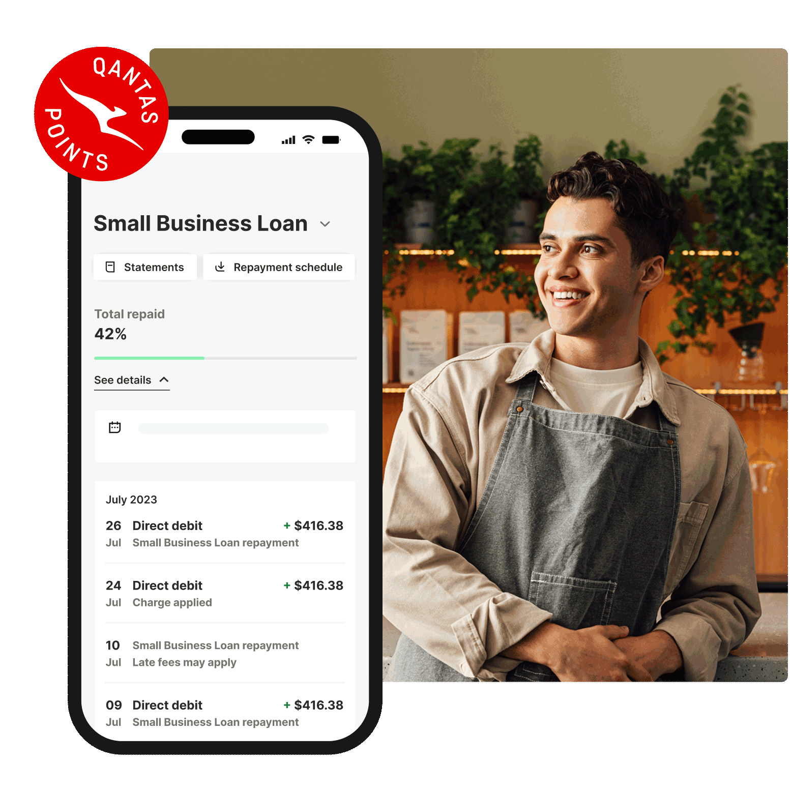 Qantas Points small business loan repayment screen shown on a smartphone next to a café worker standing inside a coffee shop