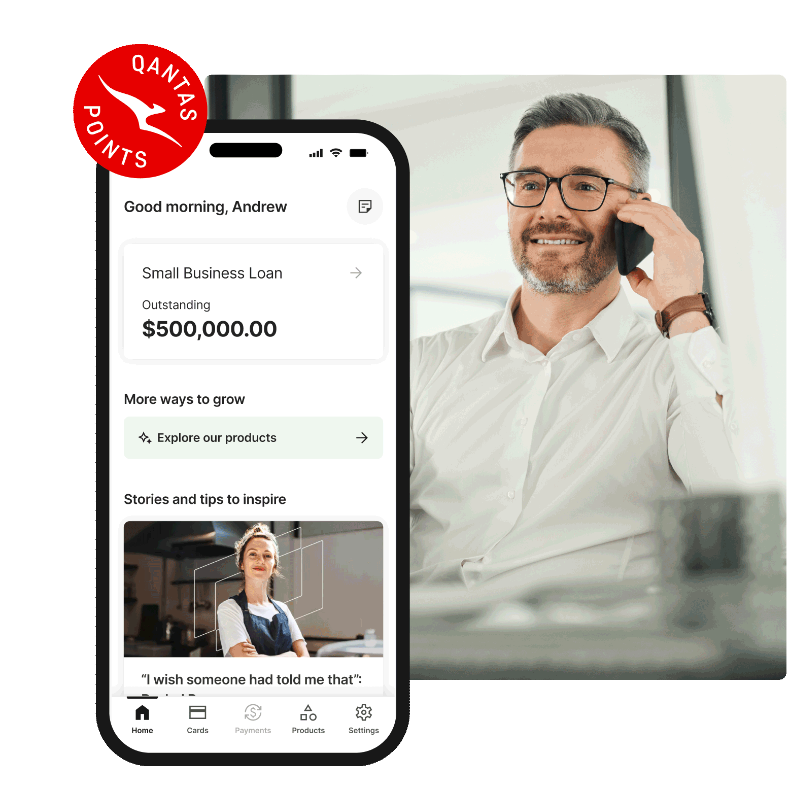 Qantas Points small business loan dashboard shown on a smartphone beside a person in a modern office environment on a phone call.