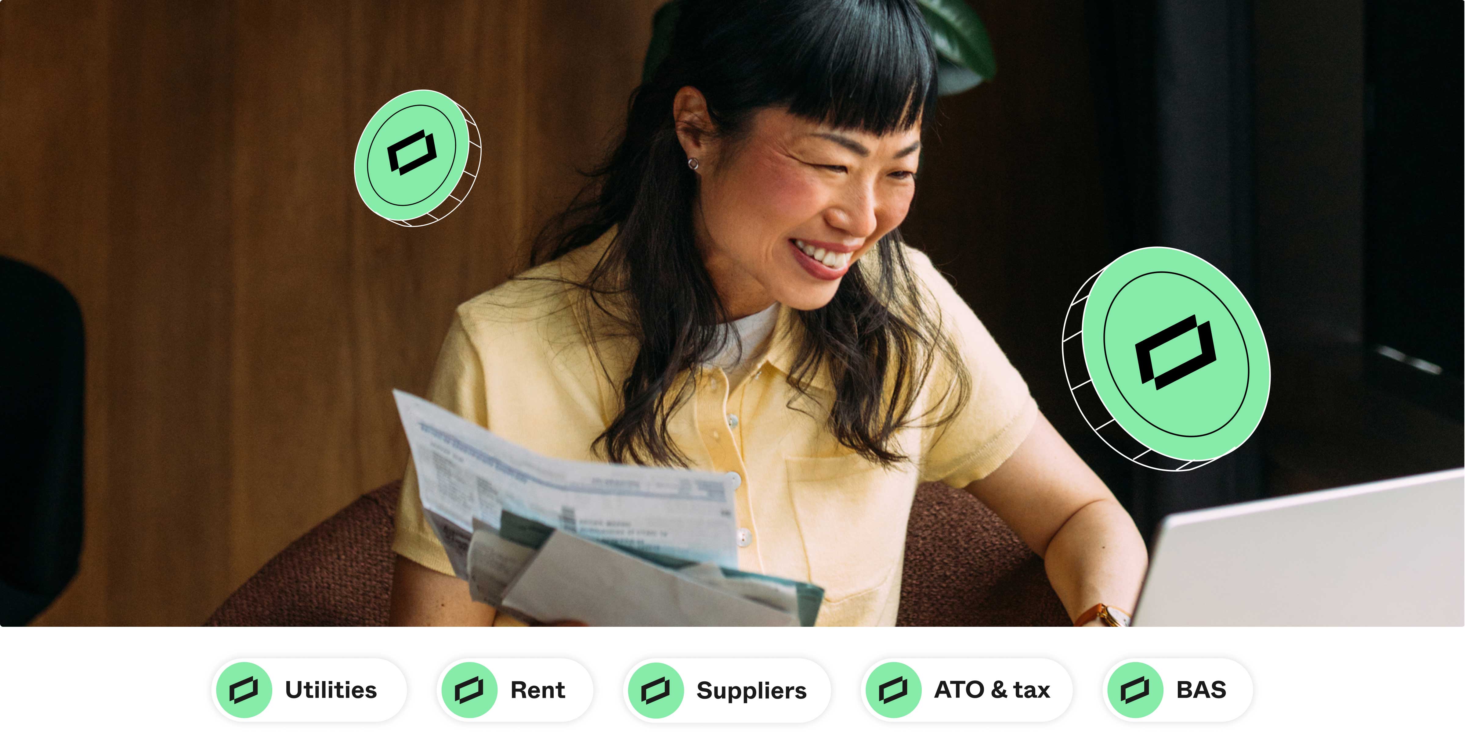 Person reviewing bills while using a laptop, with floating payment icons representing expenses like utilities, rent, suppliers, tax and BAS