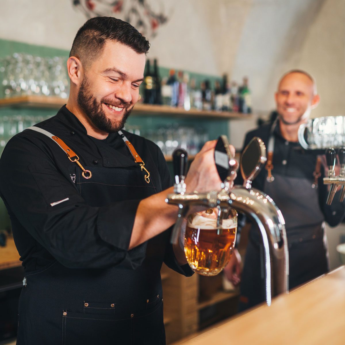Barmen smiling while working